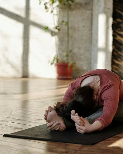 Person doing morning yoga stretches in a bright room